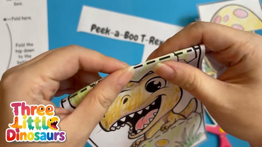 Fold the T-Rex egg craft along the fold line
