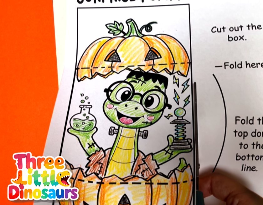 Cutting the Leonardo Frankenstein dinosaur pumpkin fold card with scissors